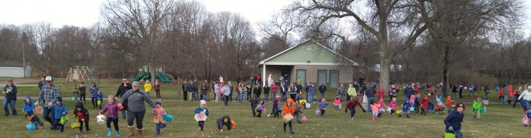 Easter Egg Hunt, children and families running around with Easter eggs.